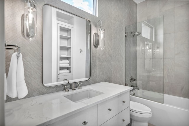 full bathroom with vanity, toilet, and enclosed tub / shower combo