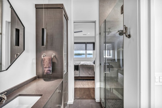 bathroom with vanity, a shower with shower door, and tile patterned flooring