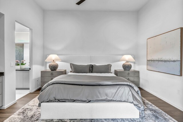 bedroom with dark hardwood / wood-style flooring and ceiling fan