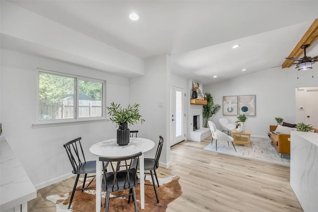 2110 Malvern Hill Dr, Austin, TX 78745 - dining room with a fireplace, light wood finished floors, recessed lighting, and baseboards