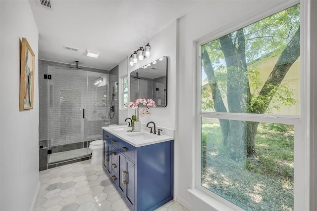 2110 Malvern Hill Dr, Austin, TX 78745 - full bath featuring a stall shower, double vanity, plenty of natural light, and toilet