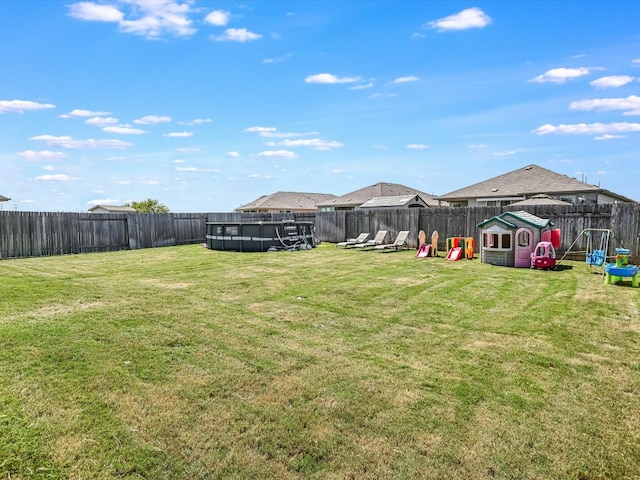 view of yard featuring a playground and a swimming pool