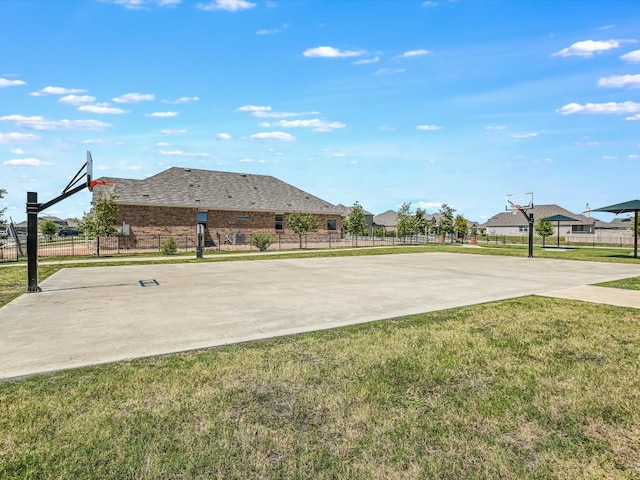 view of sport court featuring a lawn