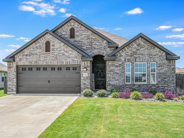 view of front of house featuring a garage and a front lawn