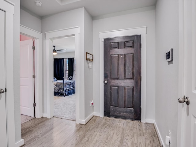 entryway with light wood-type flooring and ceiling fan