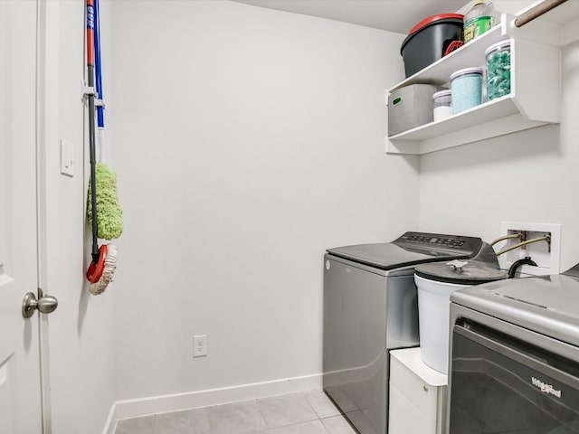 laundry room featuring light tile patterned floors and washer and dryer