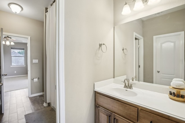 bathroom featuring ceiling fan, hardwood / wood-style flooring, and vanity