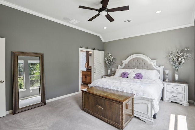 carpeted bedroom with crown molding, ensuite bath, a barn door, lofted ceiling, and ceiling fan