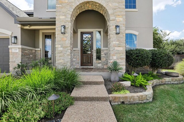 doorway to property featuring a lawn