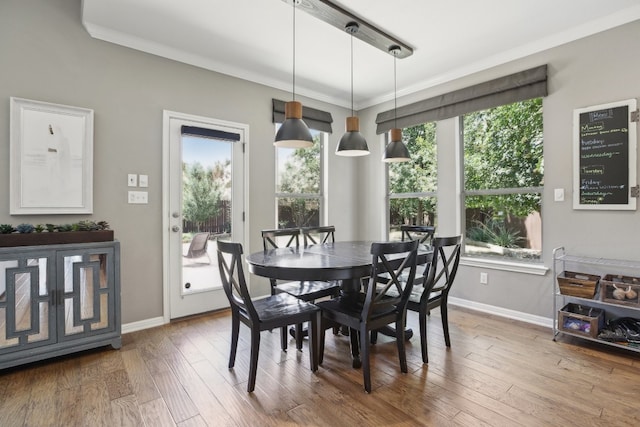 dining area featuring hardwood / wood-style floors and ornamental molding