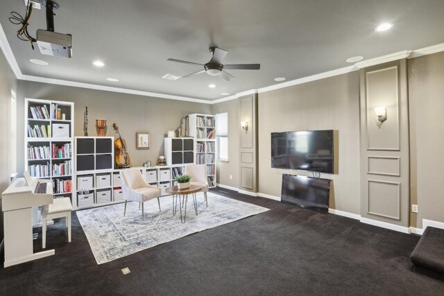 living room with ceiling fan, dark colored carpet, and ornamental molding