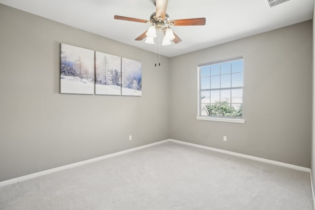 carpeted spare room featuring ceiling fan