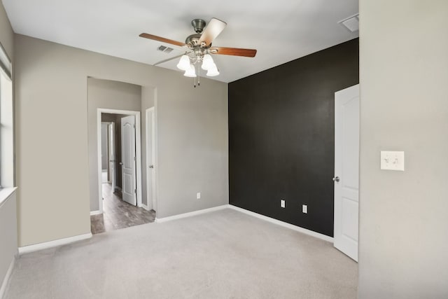 carpeted empty room with ceiling fan