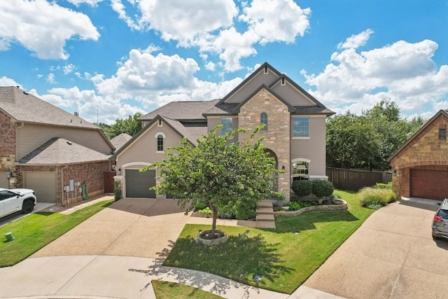 view of front of property featuring driveway, a garage, stone siding, and stucco siding
