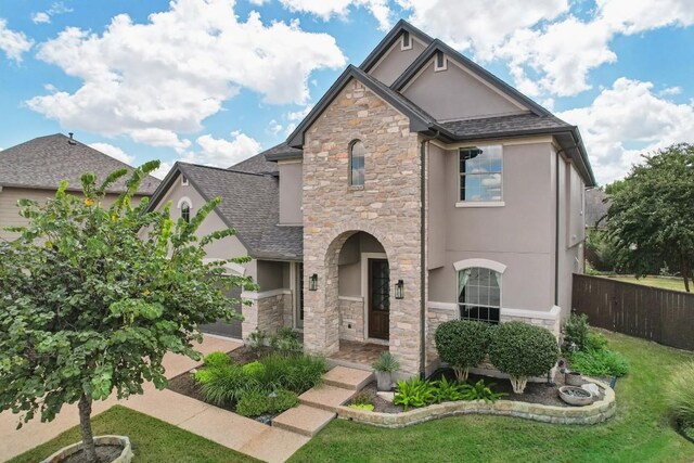 2717 Highland Trl, Leander, TX 78641 - view of front of house with stone siding, stucco siding, and a shingled roof