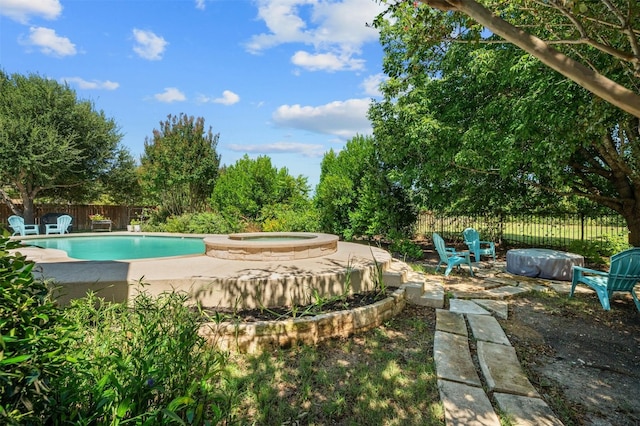 view of pool featuring an in ground hot tub