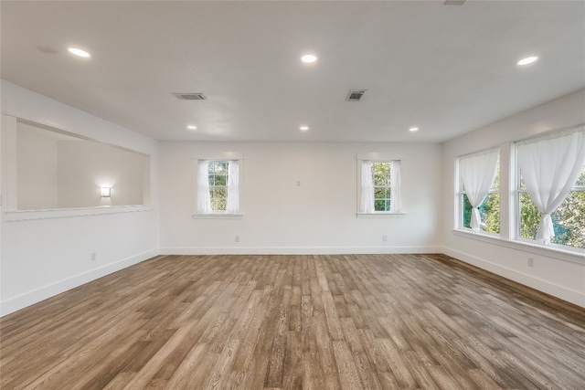 unfurnished room with wood-type flooring