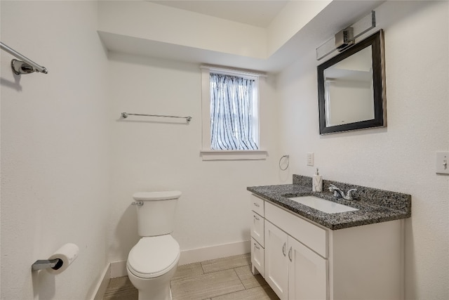 bathroom featuring vanity, toilet, and tile patterned floors