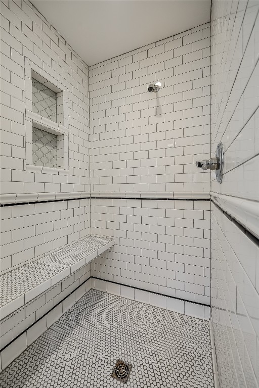 bathroom with tiled shower