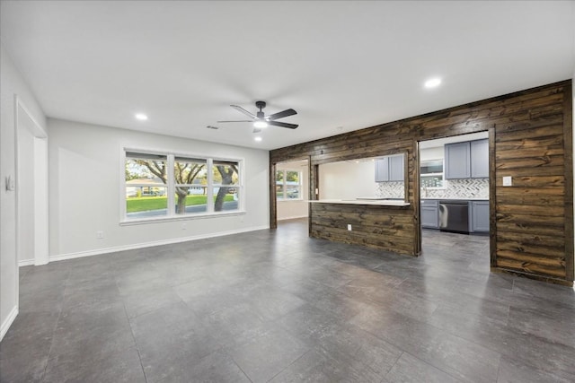 unfurnished living room with ceiling fan and a healthy amount of sunlight