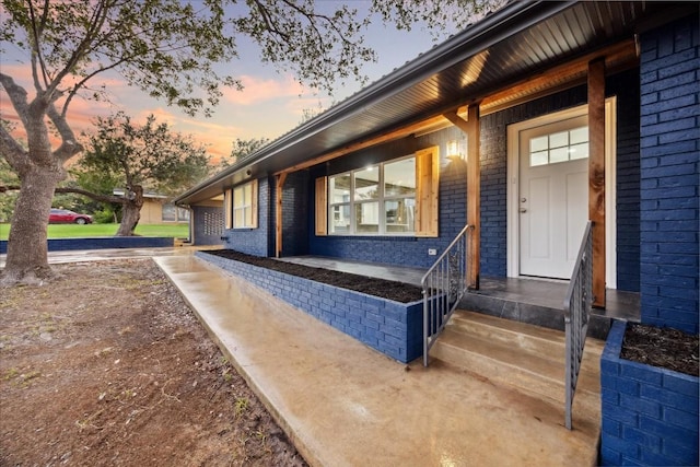 view of exterior entry at dusk