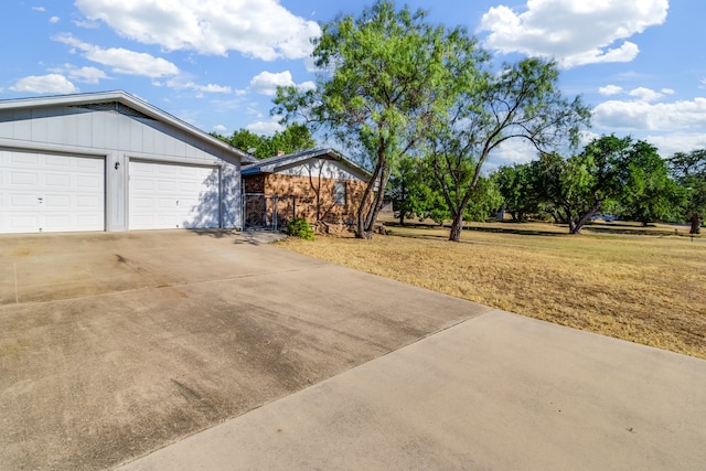 view of home's exterior with a garage and a yard