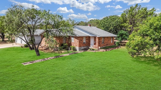 view of front of home with a front lawn and a garage