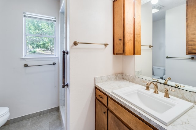 bathroom with tile patterned floors, vanity, and toilet