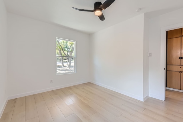 spare room with light hardwood / wood-style flooring and ceiling fan