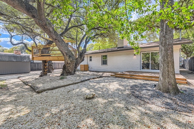 back of property featuring a wooden deck