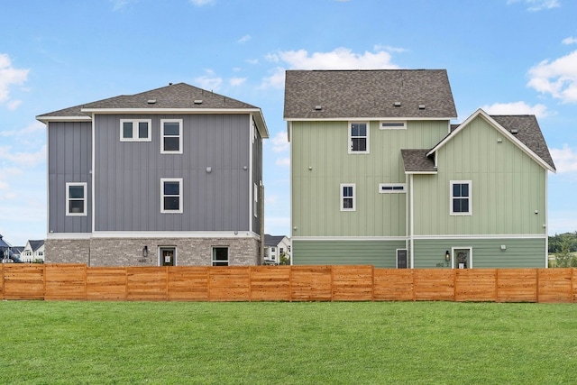 back of house with a lawn