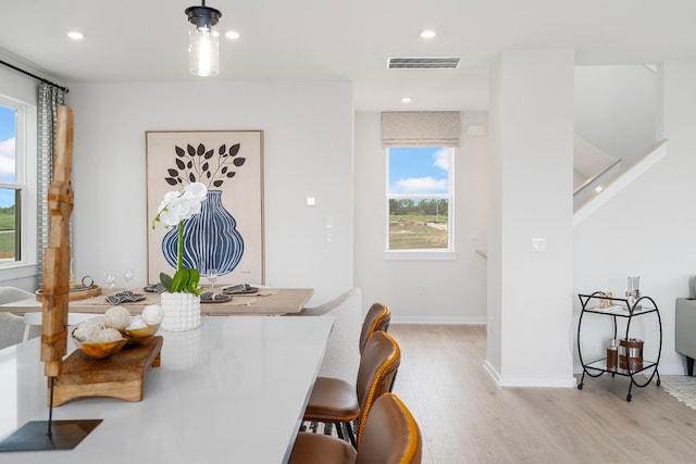 dining space with light hardwood / wood-style flooring