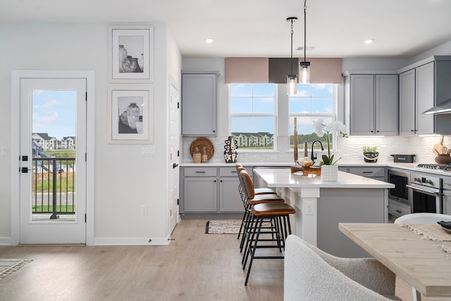 kitchen featuring plenty of natural light, a center island, and light wood-type flooring