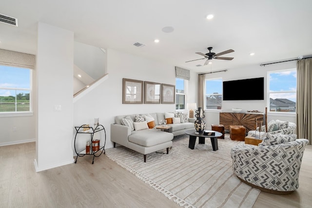 living room with ceiling fan and light hardwood / wood-style floors