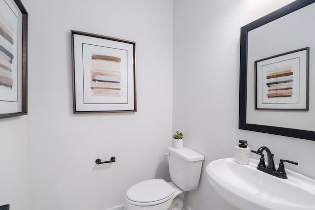 bathroom featuring toilet and sink