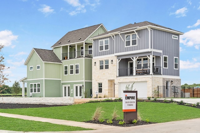 view of front of house featuring a balcony and a front yard