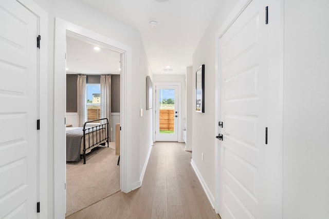 corridor with light wood-type flooring