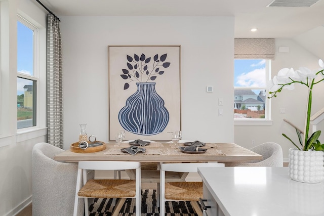 dining space featuring wood-type flooring and a wealth of natural light