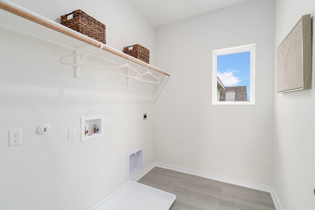 laundry area featuring hookup for a washing machine, hardwood / wood-style floors, electric dryer hookup, and hookup for a gas dryer