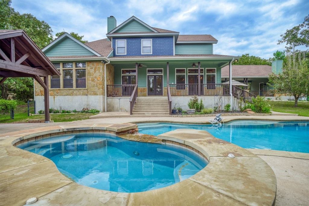 rear view of property featuring ceiling fan