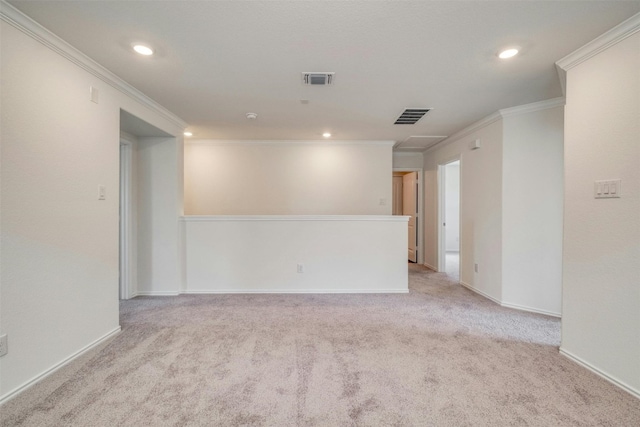 spare room featuring light carpet and crown molding