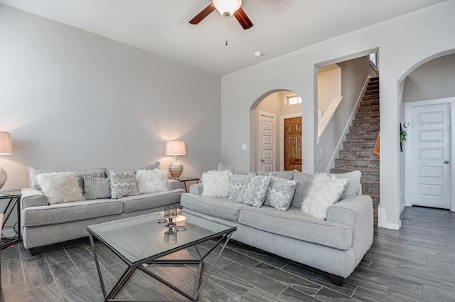 living room featuring dark wood-type flooring and ceiling fan