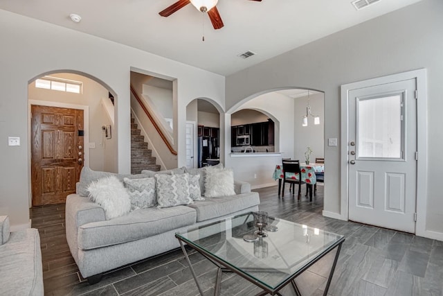 living room with ceiling fan and dark hardwood / wood-style floors