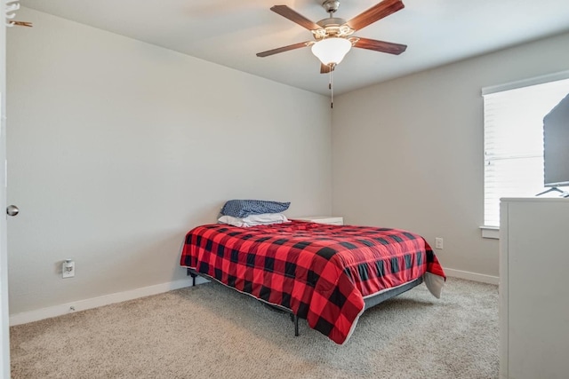 bedroom featuring ceiling fan and light carpet