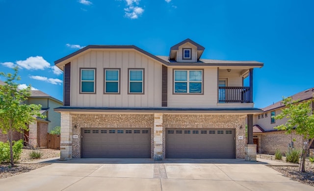 view of front of property featuring a garage and a balcony