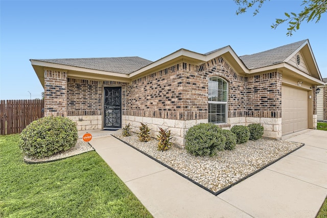 ranch-style home featuring a garage and a front yard