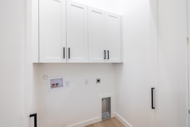 clothes washing area featuring light wood-type flooring, cabinets, hookup for a washing machine, hookup for an electric dryer, and hookup for a gas dryer