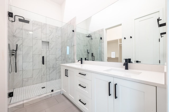 bathroom featuring tile patterned flooring, vanity, and walk in shower