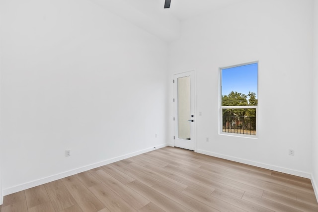 spare room with light wood-type flooring and ceiling fan