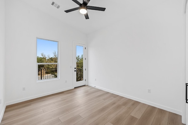 spare room featuring ceiling fan, light wood-type flooring, and vaulted ceiling